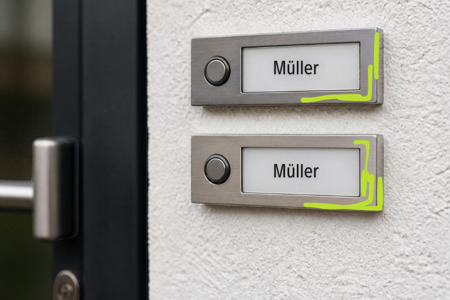 Two identical doorbell plates with the name Müller one above the other on a white wall, outlined in green