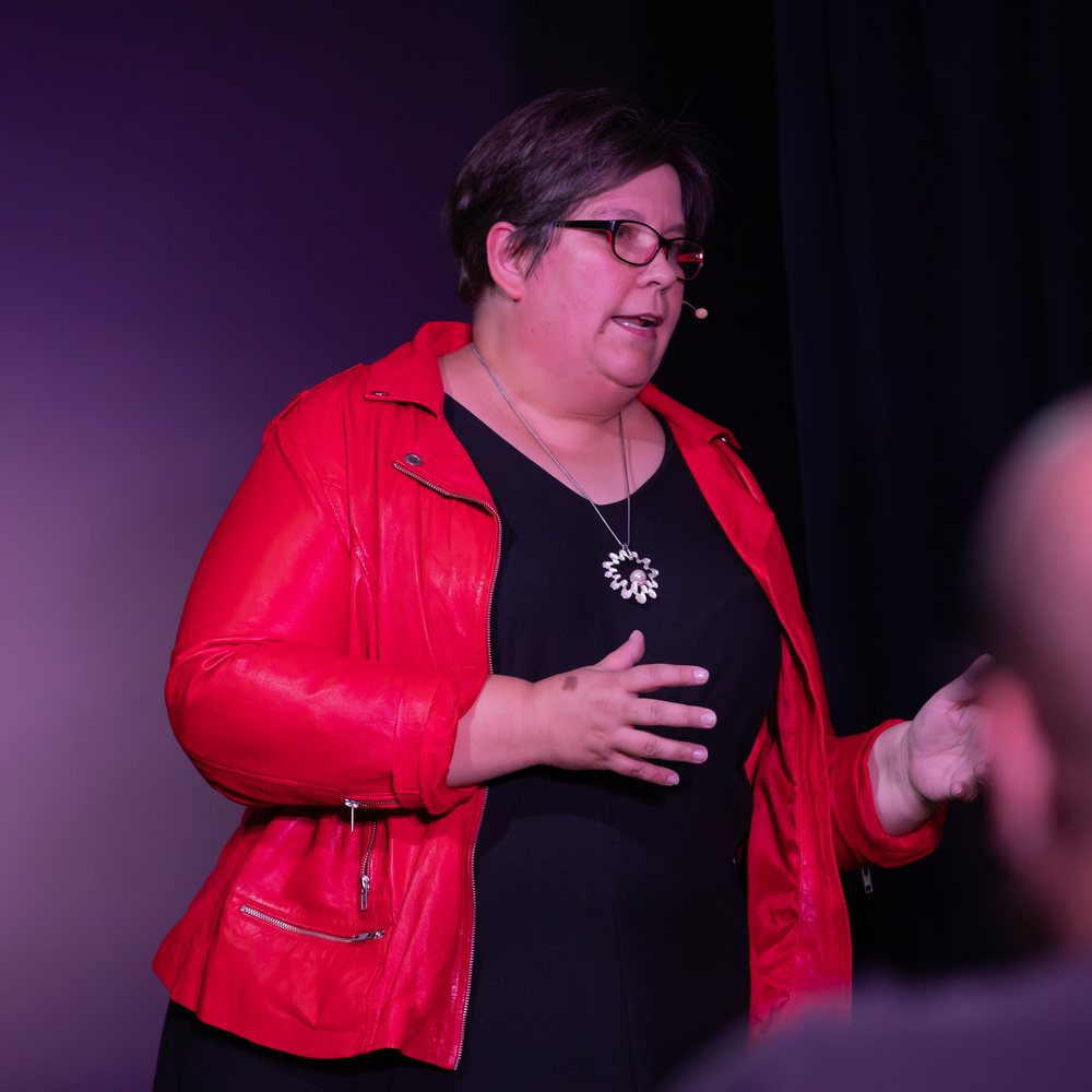 Stephanie Selmer auf der Bühne in roter Jacke